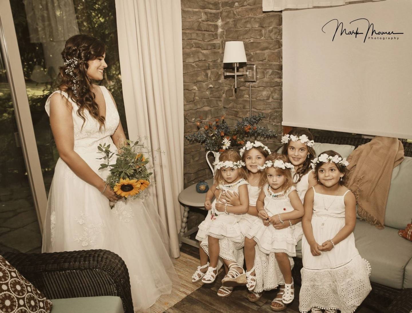 bride posing with the flower girls before the wedding