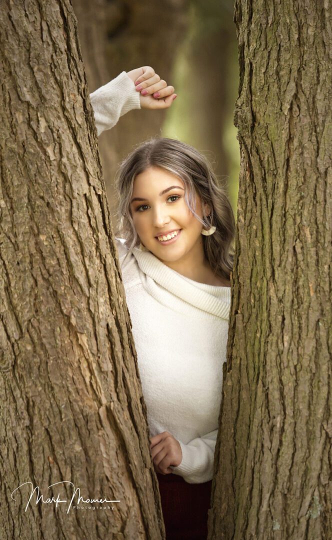 Hartwood Acres Senior Portrait of a girl posing between tree branches