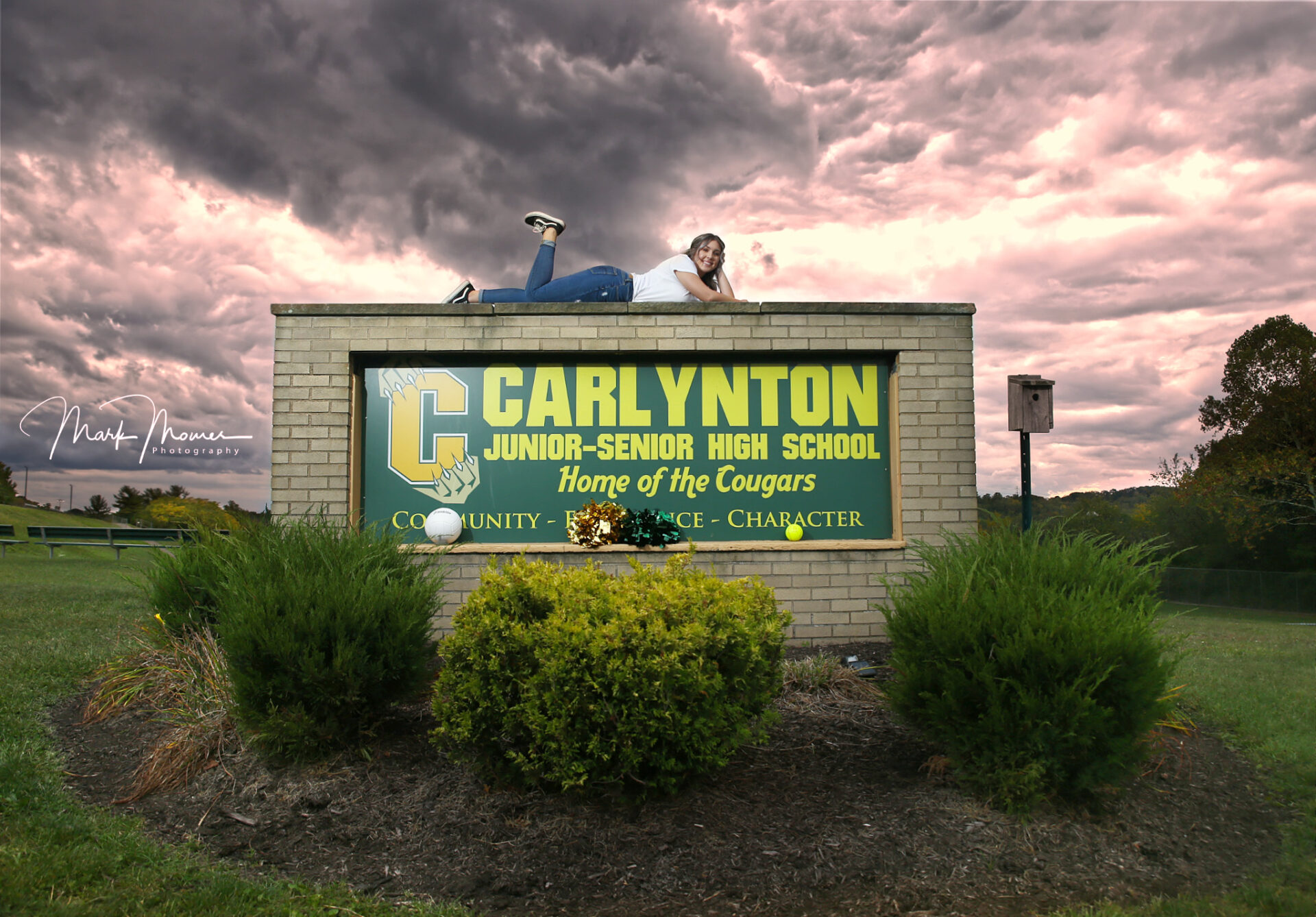 Carlynton high school senior portrait with a dramatic sky