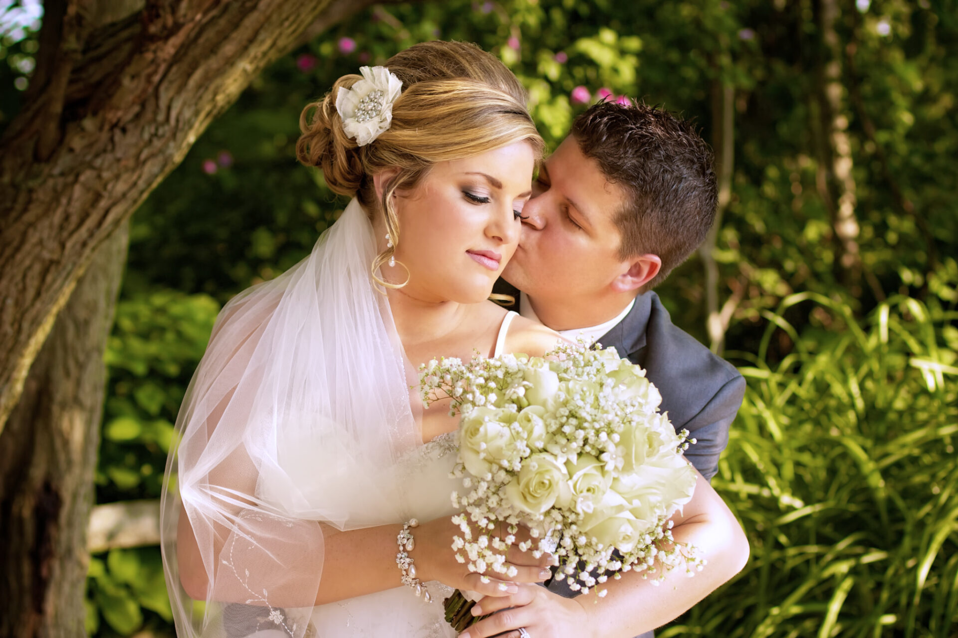 Pittsburgh bride and groom share a kiss near a garden