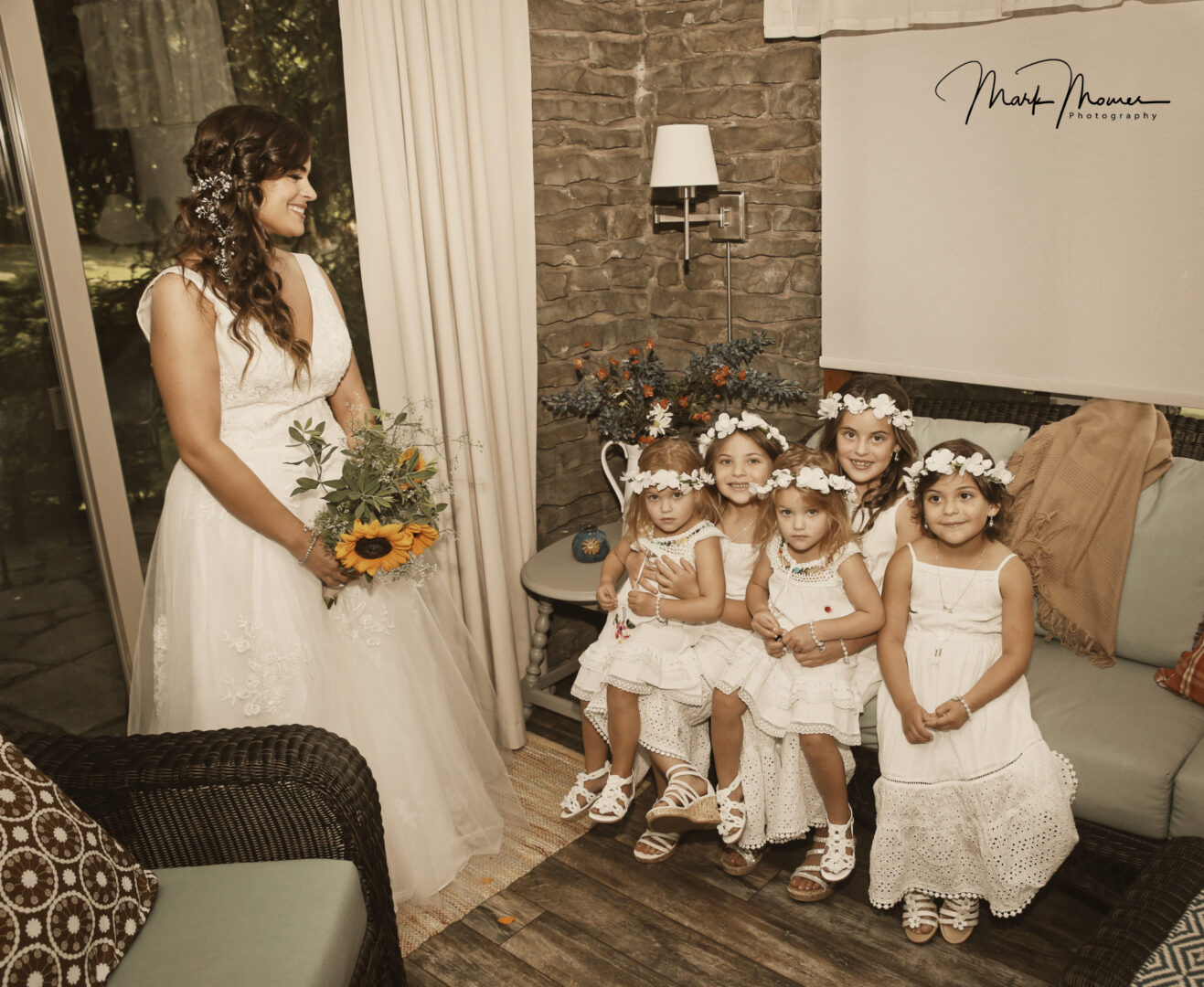 Bride and flower girls smiling for a picture