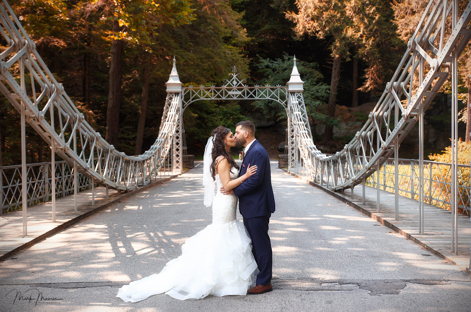 bride and groom kissing on the Cinderella bridge