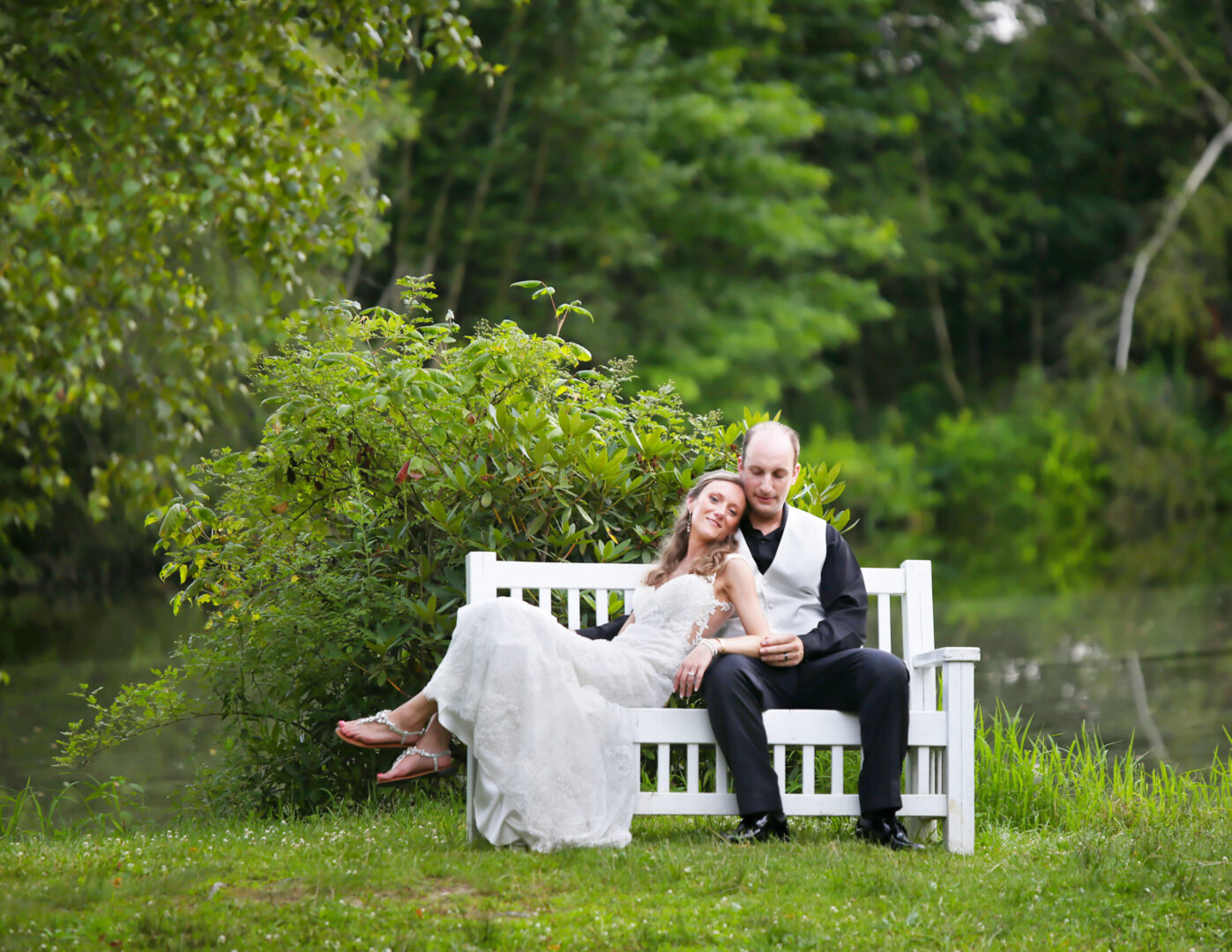 Succop Nature Park wedding with bride and groom sitting on a bench