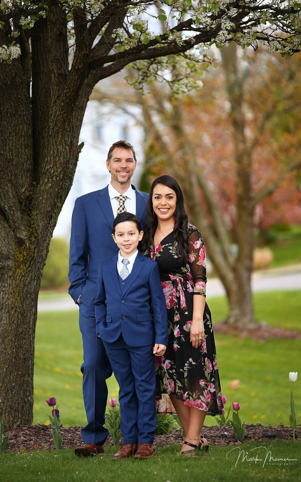 Family posing outdoors for an Easter portrait