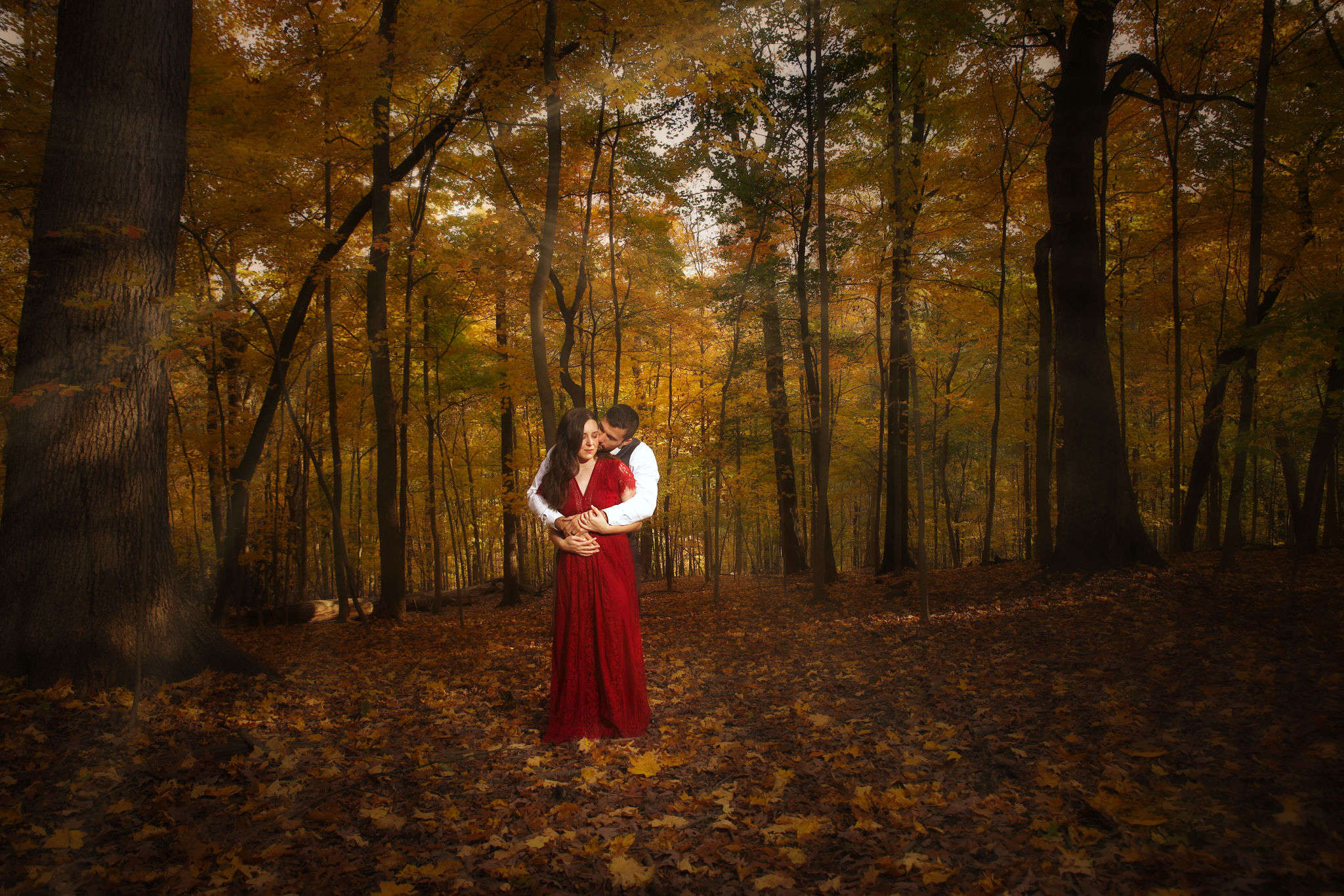 couple posing in the woods for an engagement session