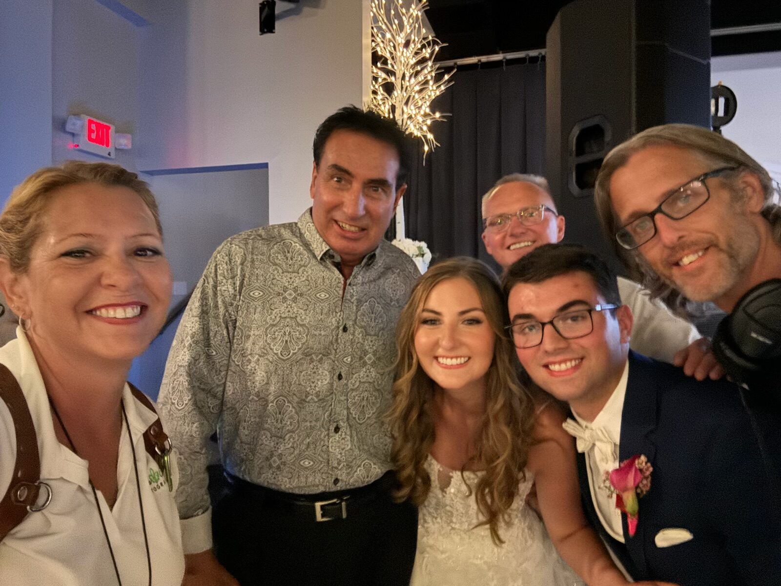 group shot of wedding vendors and the bride and groom