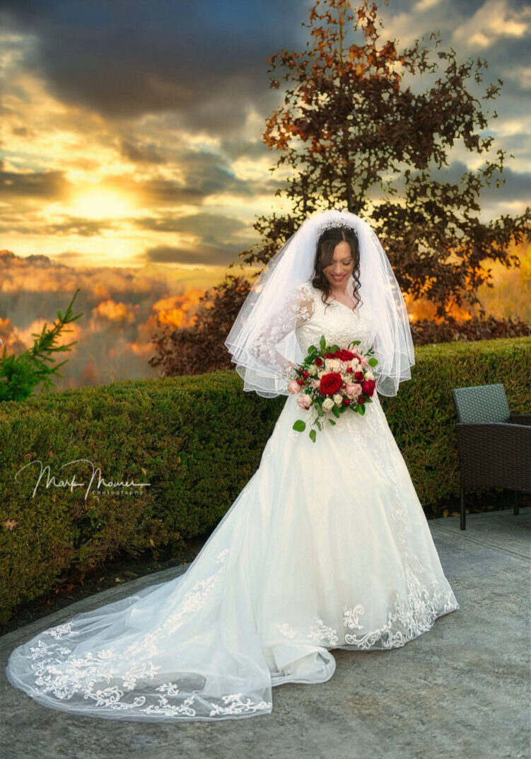 Bride posing with a dramatic sky background